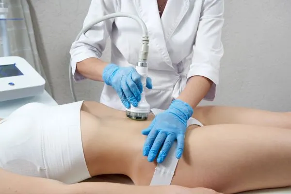 Lost the Weight but Not the Loose Skin? 2 woman having HIFU treatment on her stomach to combat loose skin Wooburn Green following weight loss